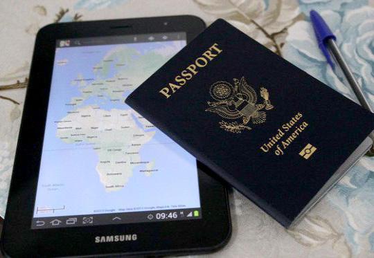 New United States passport book and tablet showing map of Africa and Europe.