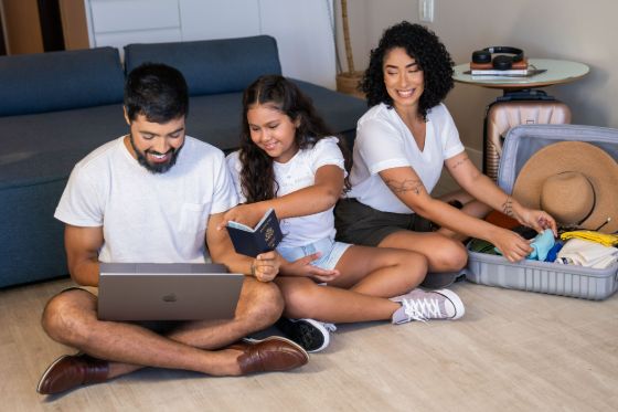 A family applies for a passport together using a laptop