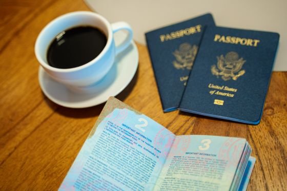 An damaged passport book laying open with an obvious coffee stain