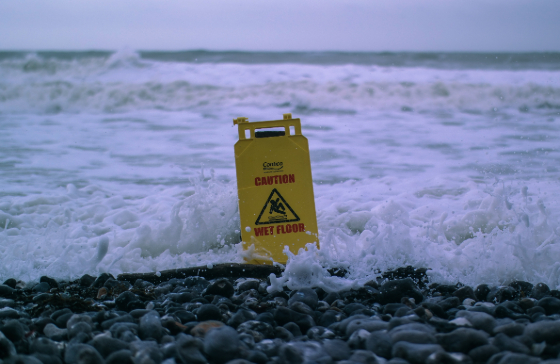 a wet floor sign in the ocean
